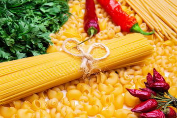variety of italian pasta like Spaghetti, pipe rigate, cavatappi, herbs, garlic, pepper and tomatoes