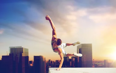  extreme sport, parkour and people concept - young man jumping high over tokyo city background © Syda Productions