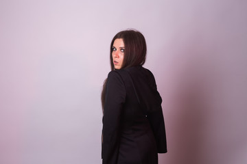 Fototapeta premium Gothic young woman in witch halloween costume on background with copy space