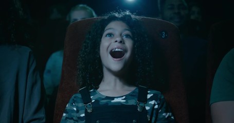 A 9 year old girl in a movie theatre is awestruck by an amazing moment.