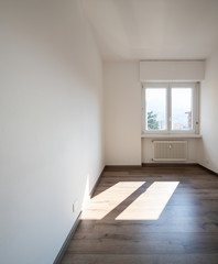 Empty room with parquet and window with a view