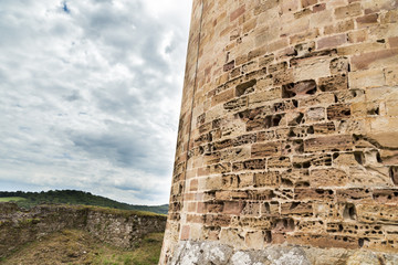 Wall of Castle of Najac, France with cloudy sky
