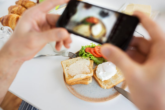 food , eating and technology concept - hands with smartphones photographing breakfast on plate