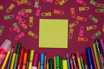 Sticky note, pencils on colorful background, blank copy space