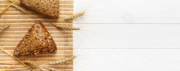 Several small multi grain triangular shaped bread sprinkled with whole sunflower seeds. banner for advertising and design, promo top view with copy space