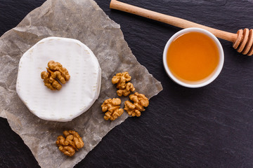 delicious creamy camembert cheese on a wooden rustic background