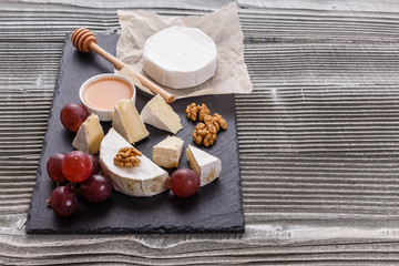 delicious creamy camembert cheese on a wooden rustic background
