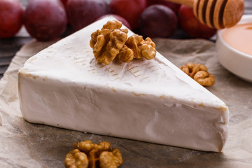 delicious creamy camembert cheese on a wooden rustic background
