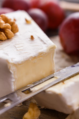 delicious creamy camembert cheese on a wooden rustic background