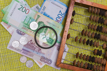 Wooden abacus and Russian cash, coins and banknotes.