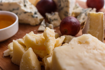 set of different cheeses on a wooden rustic background