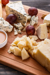 set of different cheeses on a wooden rustic background