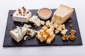 set of different cheeses on a wooden rustic background