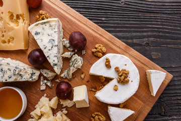 set of different cheeses on a wooden rustic background