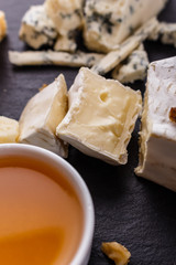 set of different cheeses on a wooden rustic background