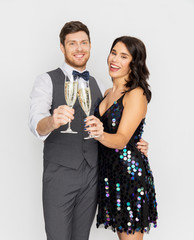celebration and holidays concept - happy couple with glasses drinking non alcoholic champagne at...
