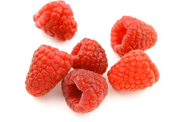 fresh red raspberry fruits isolated on a white background