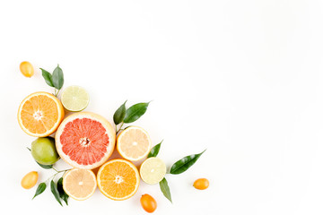 Fototapeta na wymiar Creative layout made of summer tropical fruits: grapefruit, orange, lemon, lime and leaves ficus. Food concept. flat lay, top view