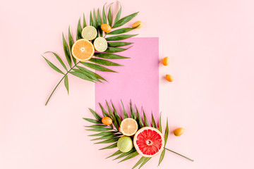 Creative layout  made of paper and summer tropical fruits on pink background. Food concept. flat lay, top view
