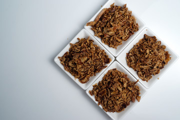 spices fried red onion in bowls on white background