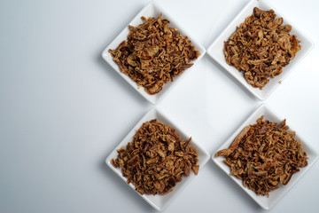 spices fried red onion in bowls on white background