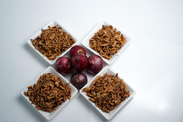 spices fried red onion in bowls on white background