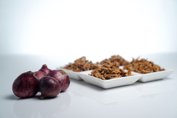spices fried red onion in bowls on white background