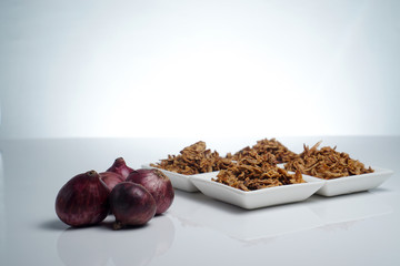 spices fried red onion in bowls on white background