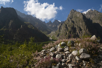 Mountain landscape, green peaks and clouds.