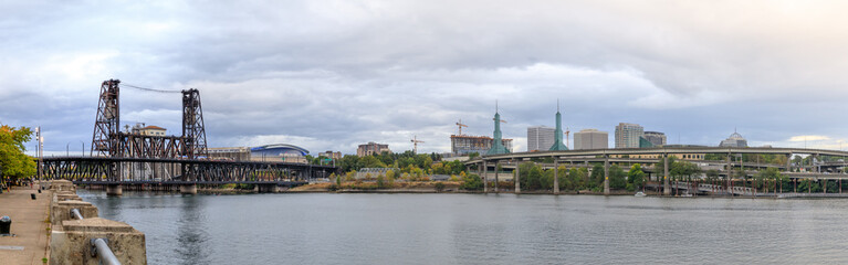 Steel bridge over Willamette river with Portland skyline