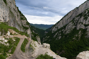 Mountain landscape, green peaks and clouds.