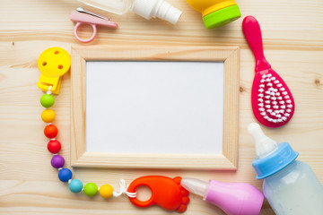 Baby yellow booties. Children's shoes and toys on white wooden boards background. Newborn.