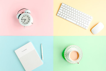 Desk with office accessories with computer, white alarm clock, notepad on colorful background. Trendy minimal style. Flat lay composition. Top view.