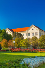     Colorful flowers on and old University building in the background in Zagreb, Croatia 