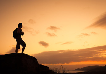 silhouette of man on top of mountain