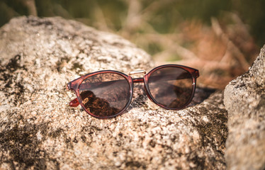Sunglasses outside on a rock for advertising nature natural