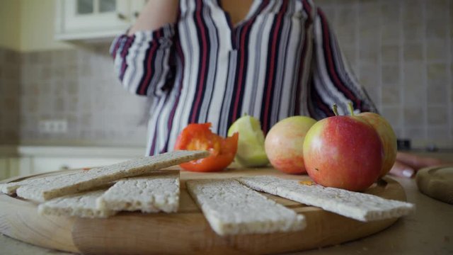Hand takes a piece of bread