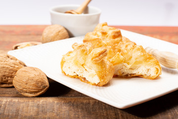 French snack pouches made from puff pastry with fresh soft goat cheese and honing