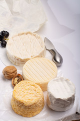 French AOC soft cow cheeses, crumbly Langres with washed rind structure, sharp Pie Angloys, camembert with strong taste and brie served as dessert after dinner