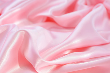 The texture of the satin fabric of pink color for the background  