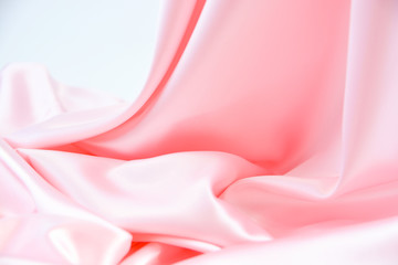 The texture of the satin fabric of pink color for the background  