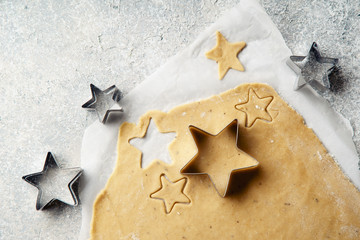 Cooking swedish ginger cookies in a star shape, cutting. Flatlay, overhead composition. Christmas atmosphere