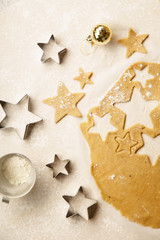 Cooking swedish ginger cookies in a star shape, cutting. Flatlay, overhead composition. Christmas atmosphere