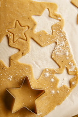 Cooking swedish ginger cookies in a star shape, cutting. Flatlay, overhead composition. Christmas atmosphere