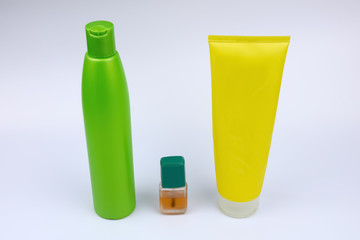 bottles with liquid and cosmetics on white background