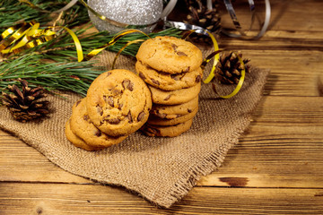 Chocolate chip cookies with Christmas decoration on wooden table