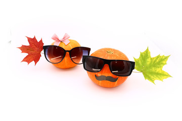 pumpkins bespectacled and maple leaves close-up, isolated