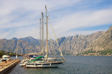 Mediterranean landscape with yachts moored at the pier. Montenegro, Adriatic Sea, Bay of Kotor