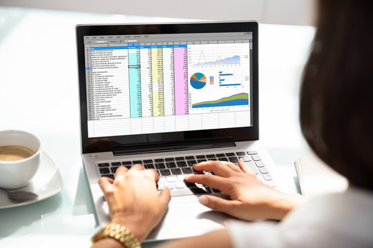 Businesswoman Working With Spreadsheet On Laptop