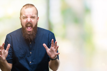 Young caucasian hipster man over isolated background crazy and mad shouting and yelling with...
